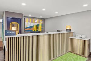 a lobby with a bar with a green rug at Spark By Hilton Prestonsburg in Prestonsburg