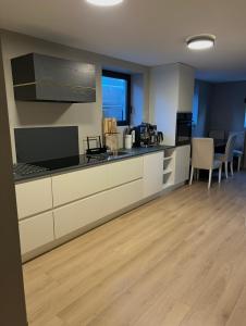 a kitchen with white cabinets and a counter top at The Eikorn House in Skien
