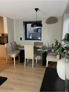 a kitchen and dining room with a table and chairs at The Eikorn House in Skien +4 photos
