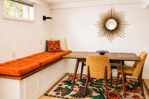 a dining room with a bench and a table and chairs at The Nest in Fort Collins