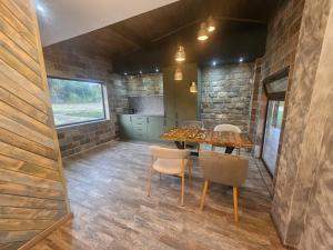 a kitchen and dining room with a table and chairs at Къща за гости Жеглица in Zheglitsa