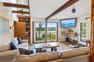 a living room with two couches and a table at Steps to Beach: Martha's Vineyard Private Retreat! in Vineyard Haven