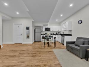 a kitchen and living room with a couch and a table at Windsor Perfect Stay in Windsor