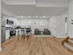 a kitchen with white cabinets and a table and chairs at Windsor Perfect Stay in Windsor