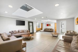 a large living room with couches and a tv at The Mitre Hotel Brighton in Brighton & Hove