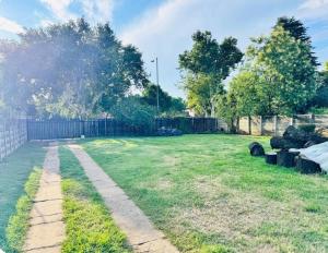 a yard with a fence and a grass field at Hei Stays One Bed Apartment in Bronkhorstspruit