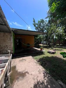 a house with a yard next to a building at Hostal Sol Naciente in Rivas