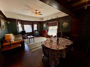 a living room with a table and a couch at Arundel Mansions Hotel in New Westminster