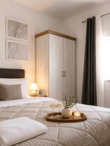 a bedroom with a bed with a tray with wine glasses on it at Villa Conceptt casa in Jasenak +69 photos