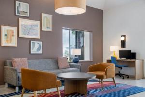 a living room with a couch and chairs and a table at Garner Hotel Sumter Northwest in Sumter