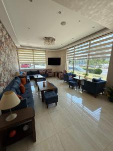 a living room with a blue couch and a tv at Motel Eros in Sandanski