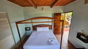 a bedroom with a bed with a wooden head board at Hotel Casa Huijazoo in Mazunte