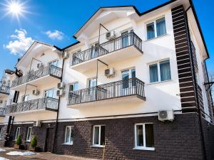 an apartment building with balconies on it at Vila LOLO in Chişinău