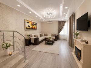 a living room with a couch and a fireplace at Vila LOLO in Chişinău