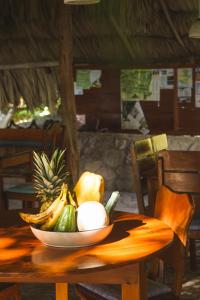 a bowl of fruit on a wooden table at Posada del Cerro in El Remate
