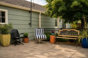 two chairs and a bench in front of a house at The Nest in Fort Collins +21 photos