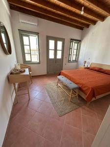 a large bedroom with a bed and a table at Marea Patmos in Skala