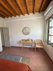 a room with a table and a mirror on the wall at Marea Patmos in Skala