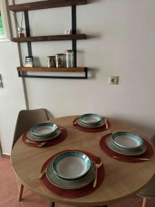 a wooden table with plates on top of it at Marea Patmos in Skala