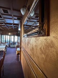 a wall in a restaurant with a mirror on it at The Orchard Estate in Sarajevo