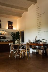 a dining room with a table and chairs at Casale Oliveta & Ristorante in Orbetello