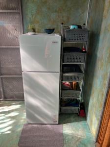a refrigerator with its door open in a room at Green TinyHome 1 in Uvita