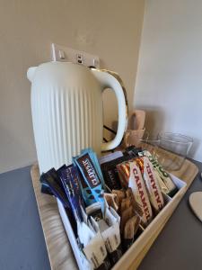 a table with a coffee pot and snacks on a tray at Clarke Cottage Guest House in Dunfermline +10 photos