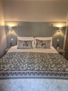 a bedroom with a large bed with two pillows at Clarke Cottage Guest House in Dunfermline