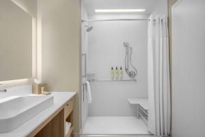 a white bathroom with a shower and a sink at Element by Marriott Boise Downtown in Boise +35 photos