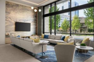 a living room with a couch and chairs and a tv at Element by Marriott Boise Downtown in Boise