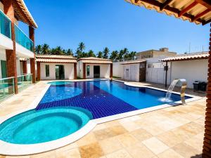 a swimming pool in the backyard of a house at Vila Bangalô in São José da Coroa Grande