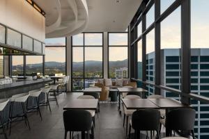 a restaurant with tables and chairs and large windows at Element by Marriott Boise Downtown in Boise