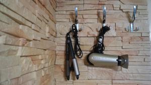 a wall with two microphones hanging on a brick wall at Design apartment MM in Poprad