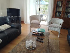 a living room with a couch and a coffee table at La Maison du Petit Port in Nantes