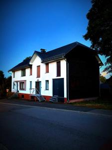 a white and red house with a black garage at Villa Serenita in Montenau