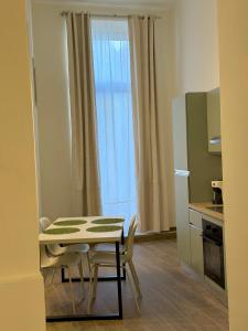 a small kitchen with a table and a refrigerator at Majella vista Mare in Guardiagrele +28 photos