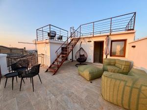 a patio with a couch and a staircase on a house at Majella vista Mare in Guardiagrele