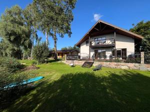 a house with a large yard in front of it at Just Chill in Riga