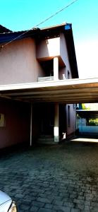 a building with a porch and a brick patio at LaLuna House in Cernik