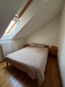 a bedroom with a bed and a skylight at Just Chill in Riga