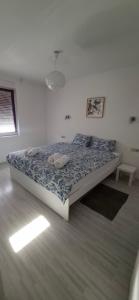 a bedroom with a bed with two pillows on it at LaLuna House in Cernik