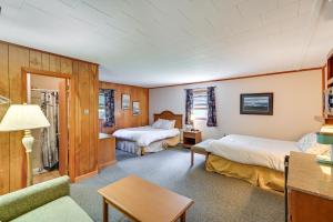a hotel room with two beds and a couch at Dock, Direct Waterfront: Lake Champlain Studio in Willsboro