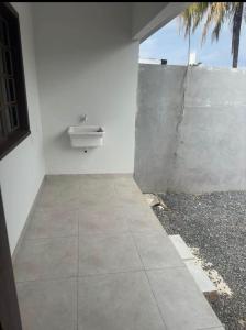 a bathroom with a sink on a white wall at Florence Nightingale in Sorriso