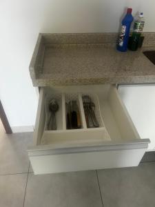 a drawer in a kitchen counter with utensils at Florence Nightingale in Sorriso