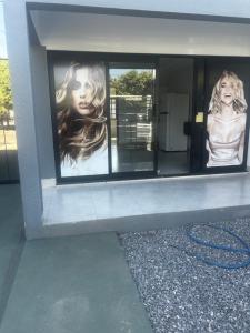 a building with two pictures of women in windows at Florence Nightingale in Sorriso +3 photos