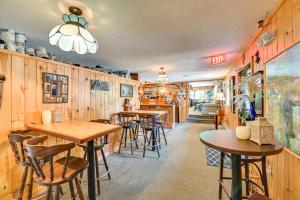 a restaurant with wooden walls and tables and chairs at Dock, Direct Waterfront: Lake Champlain Studio in Willsboro