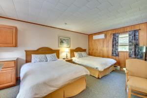 a hotel room with two beds and a chair at Lake Champlain Studio: Fish, Play & Relax in Willsboro