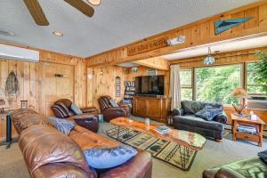 a living room with leather furniture and a flat screen tv at Lake Champlain Waterside Retreat w/ Dock Access in Willsboro