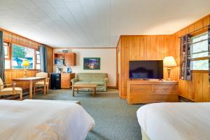 a hotel room with two beds and a flat screen tv at Lake Champlain On-Site! Waterfront Studio w/ Dock in Willsboro