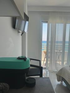 a living room with a view of the ocean at Chrisanthi Apartments in Archangelos